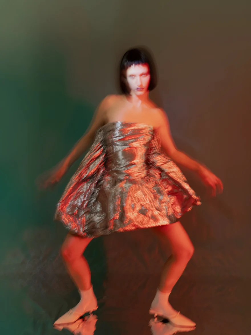 Motion-blurred image of the silver foil dress in movement, SHOT Magazine editorial photographed by Ina Cenusa