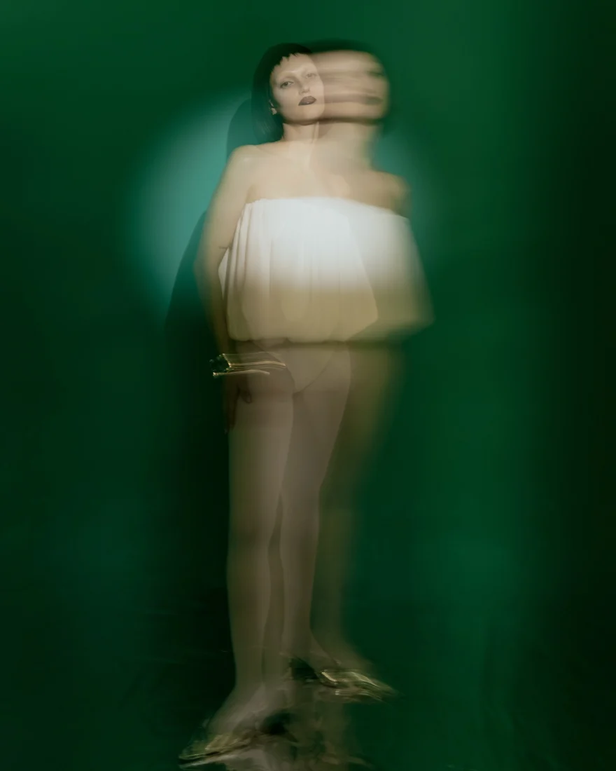 Long-exposure portrait in a white bandeau look against green, SHOT Magazine editorial photographed by Ina Cenusa