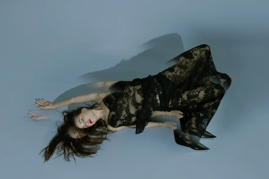 Dancer lying on the studio floor in a black lace gown, SHOT Magazine editorial photographed by Ina Cenusa