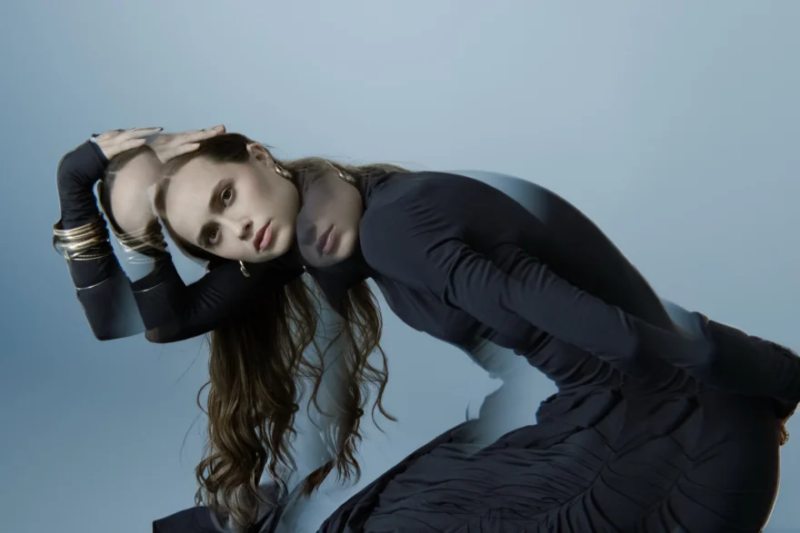 Portrait of the dancer leaning to one side in a dark long-sleeved dress, SHOT Magazine editorial photographed by Ina Cenusa