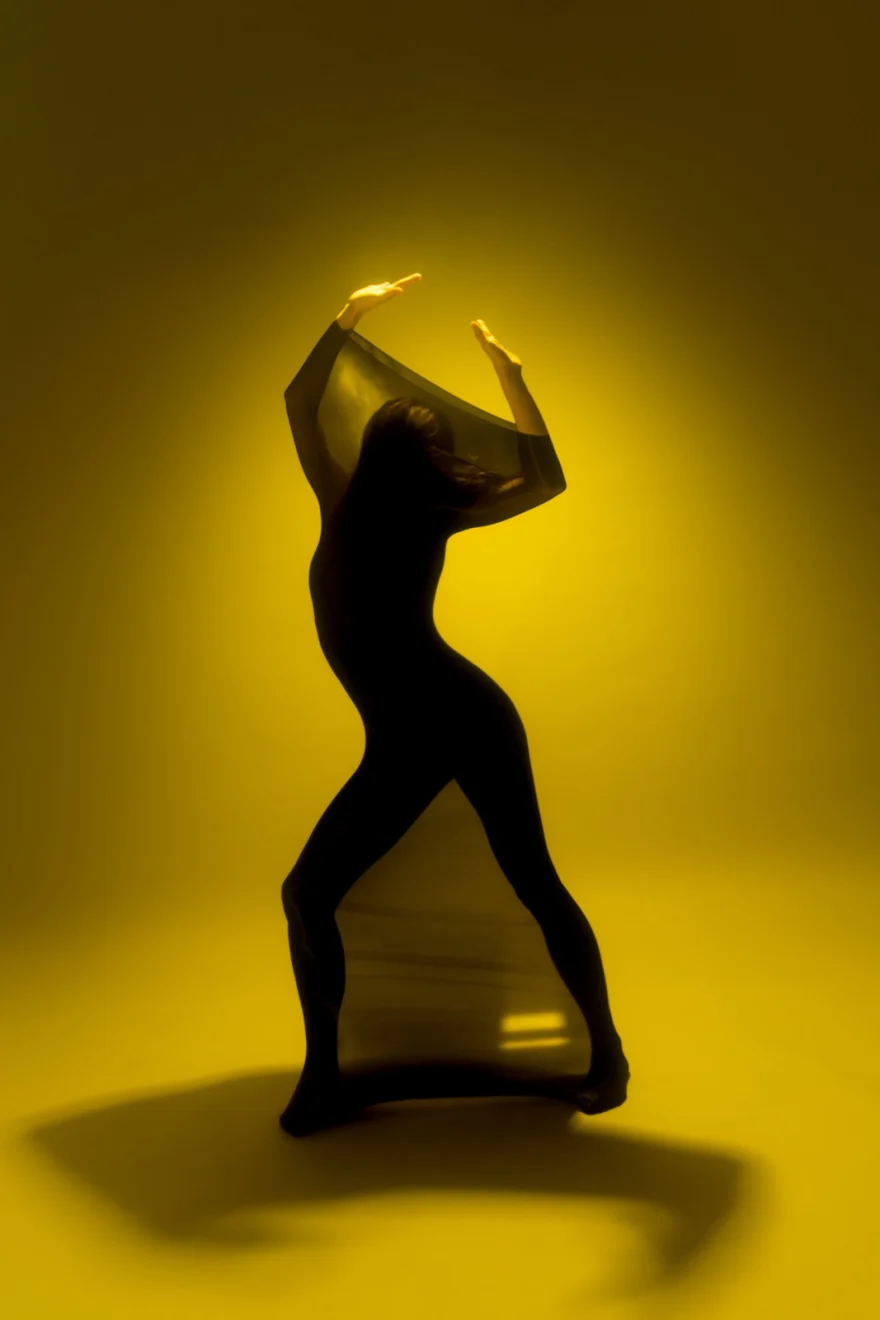 Silhouetted dance pose against a saturated yellow background, closing image of Silent Dance, SHOT Magazine editorial photographed by Ina Cenusa
