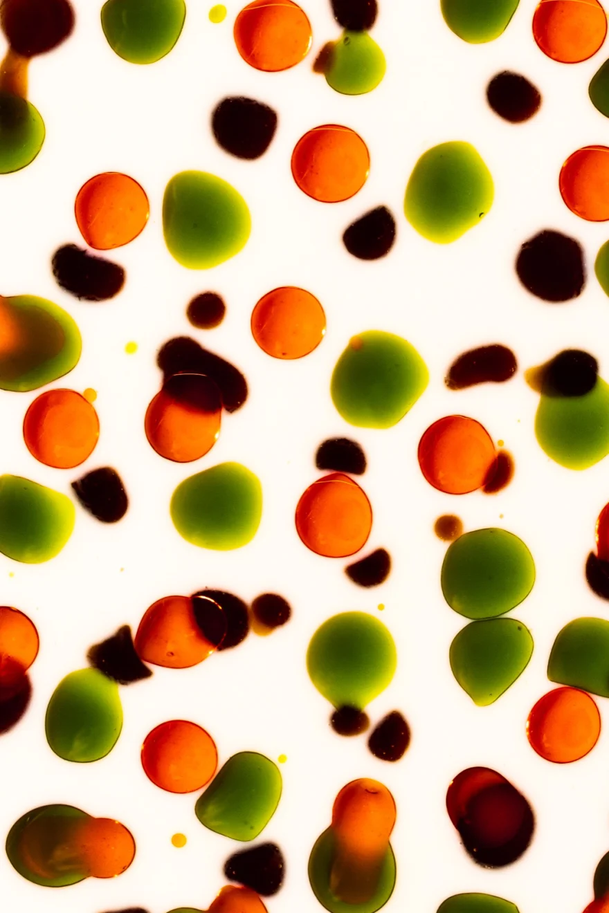 Scattered pattern of green and red olives on white, Fuoco Sacro campaign photographed by Ina Cenusa