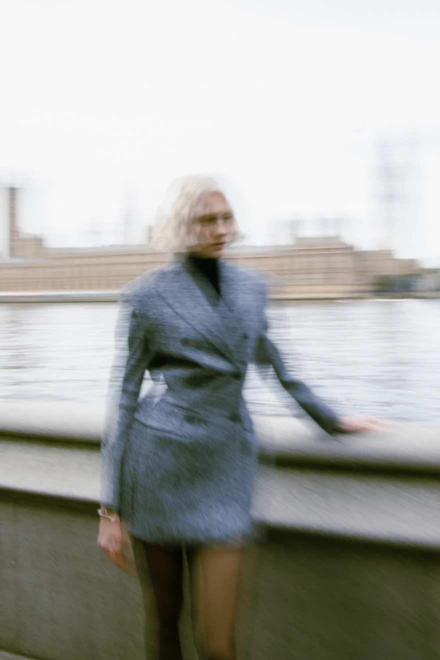 Model in a blue-grey dress by the Thames, closing image of the London campaign, Ermanno Scervino campaign photographed by Ina Cenusa