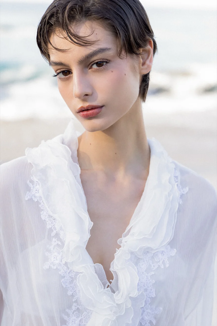 Model in a beige look against a red volcanic cliff, Ermanno Scervino campaign photographed by Ina Cenusa