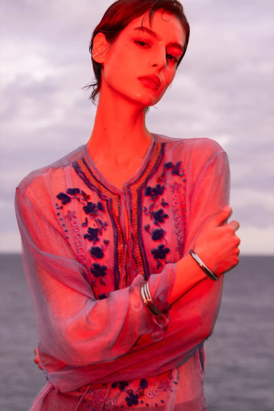 Figure lit in deep red, closing image of the Tenerife campaign, Ermanno Scervino campaign photographed by Ina Cenusa