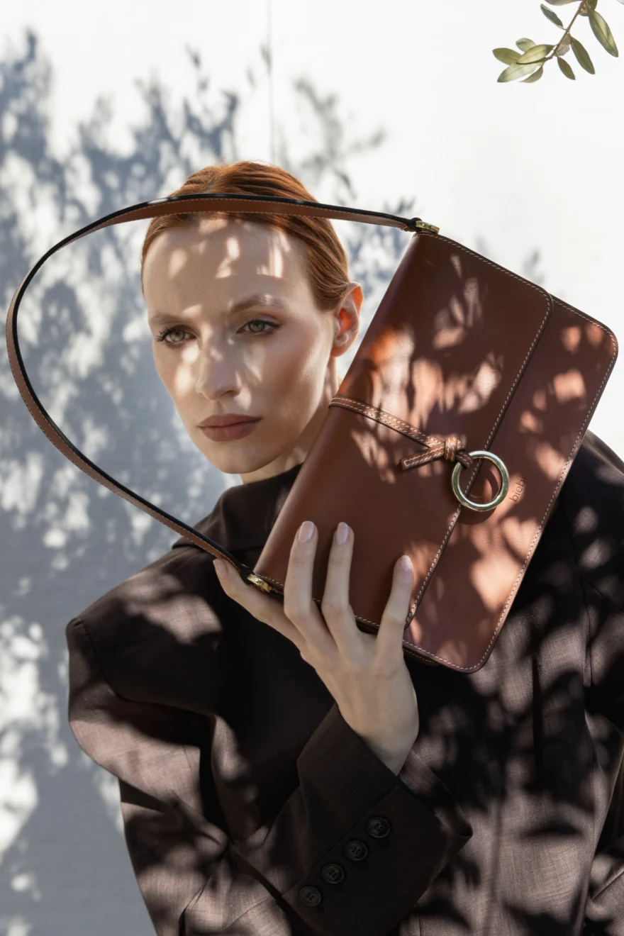 Portrait with patterned shadows falling across the face and bag, Biebi campaign photographed by Ina Cenusa