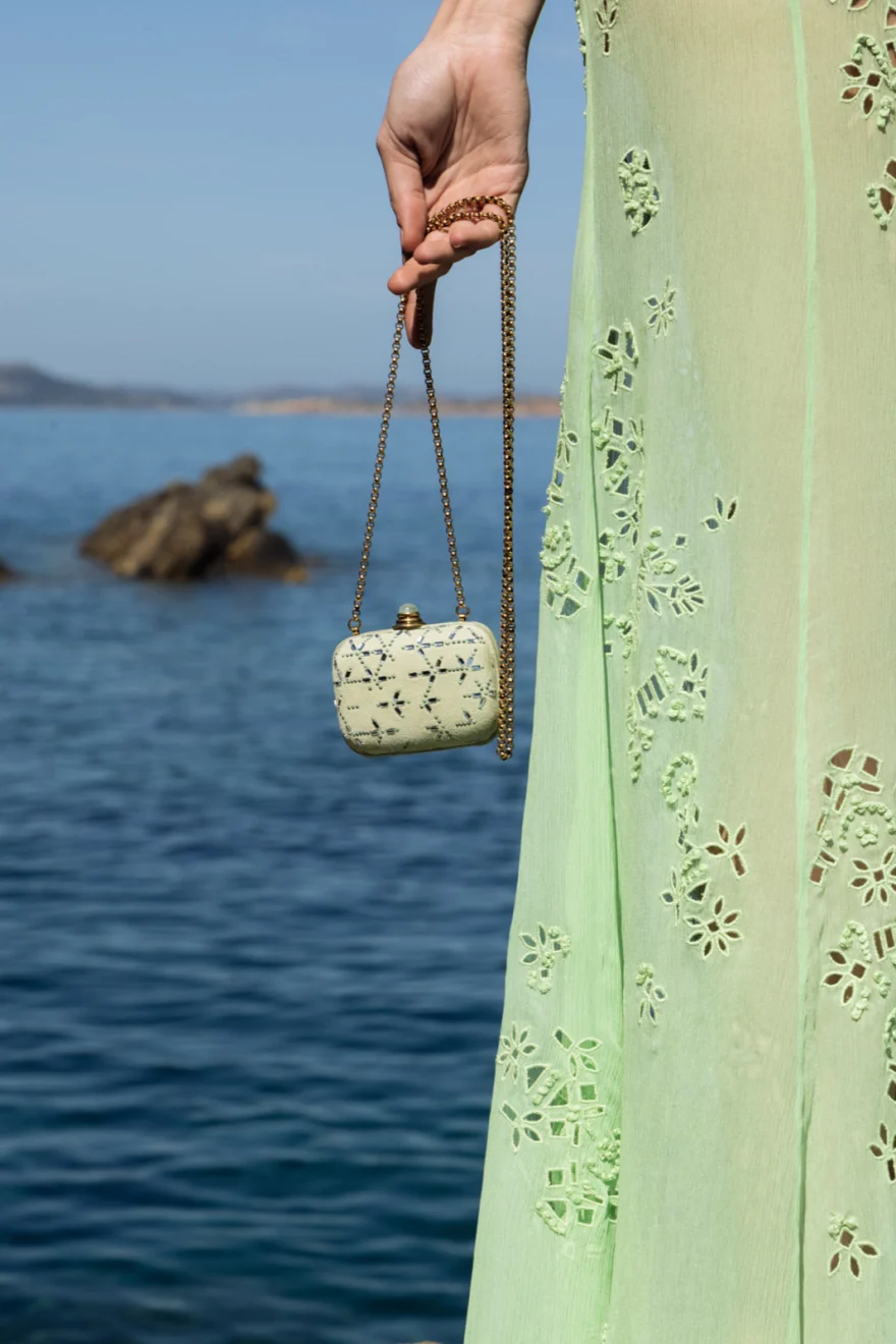 Model on granite boulders above the turquoise sea, Ermanno Scervino campaign photographed by Ina Cenusa