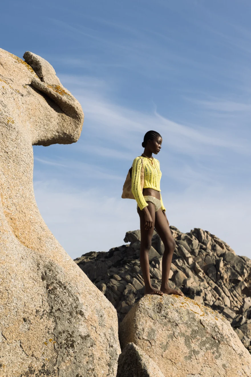 White dress against weathered granite, Ermanno Scervino campaign photographed by Ina Cenusa