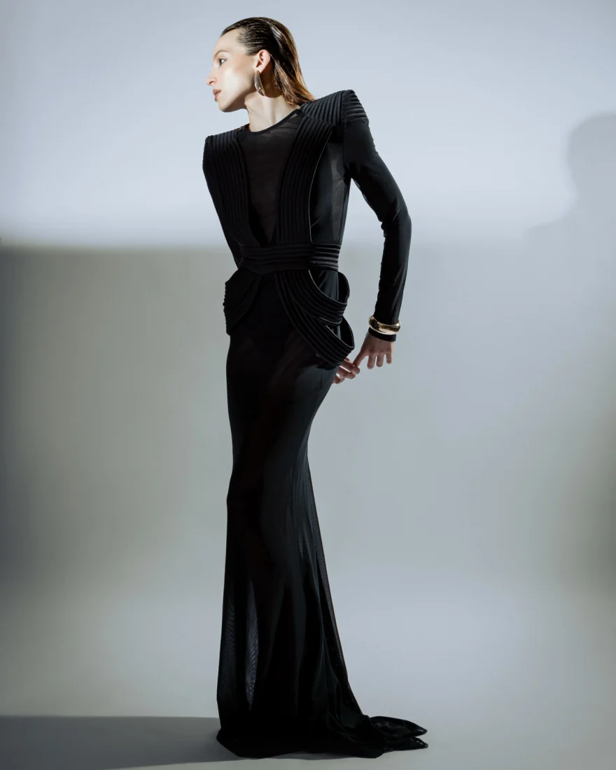 Model in a long black gown in profile against a grey studio wall, Philip Martin's campaign photographed by Ina Cenusa