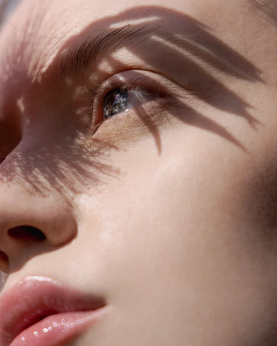 Beauty macro of lips and cheek with the shadow of the eyelashes falling across the skin, SHOT Magazine editorial photographed by Ina Cenusa