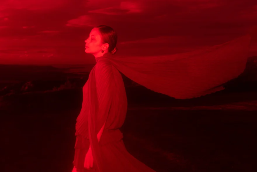 Figure with a flying cape bathed in deep red light, closing image of the story, SHOT Magazine editorial photographed by Ina Cenusa
