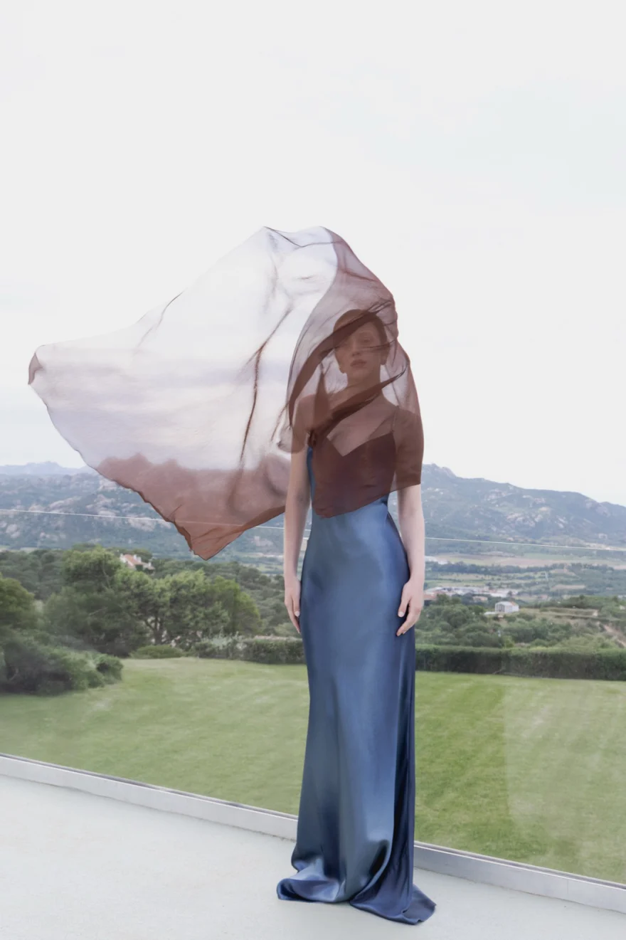 White veil lifted over denim in an open green landscape, SHOT Magazine editorial photographed by Ina Cenusa