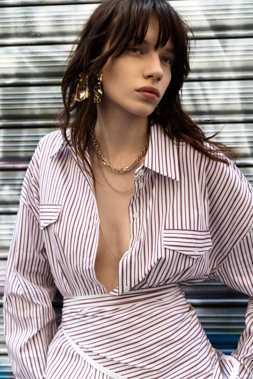 Close portrait in a striped shirt with gold jewellery, Patrizia Pepe campaign photographed by Ina Cenusa