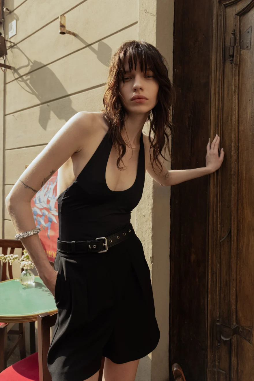 Model with a shoulder bag against a stone wall, Patrizia Pepe campaign photographed by Ina Cenusa