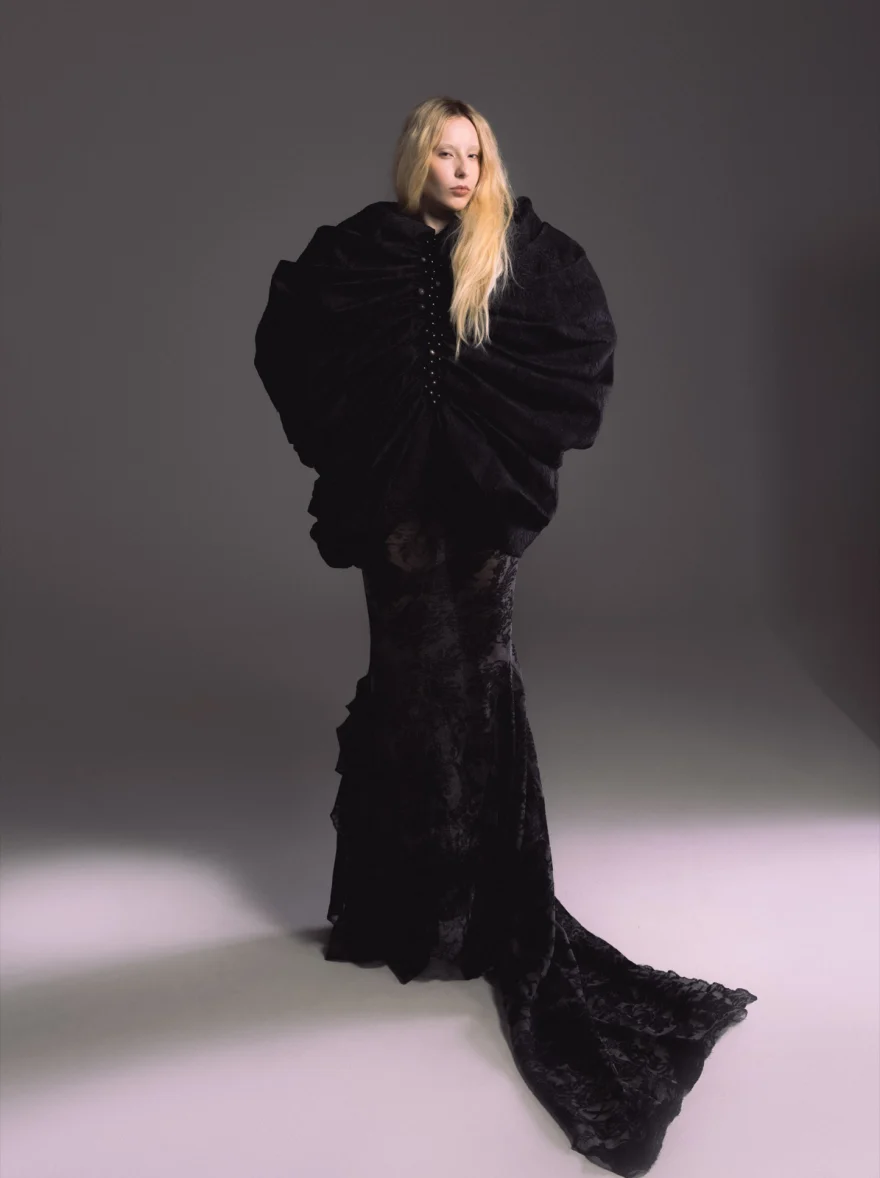 Model in a sculptural black ruffled gown with a long train, studio portrait, SHOT Magazine editorial photographed by Ina Cenusa