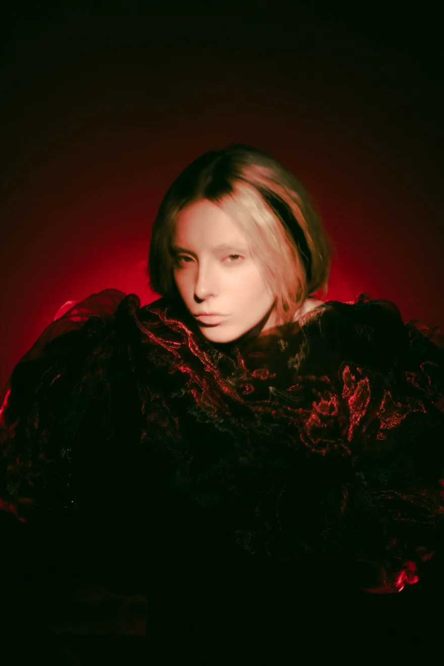 Portrait of a model in dark ruffles lit by deep red light, SHOT Magazine editorial photographed by Ina Cenusa