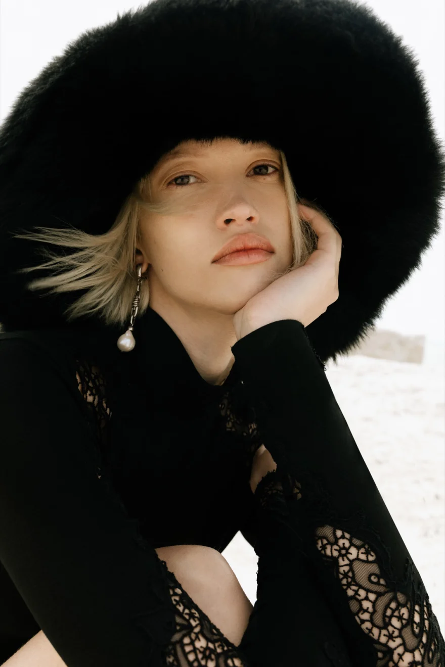 Model in a bustier and tulle skirt on the shingle beach, Ermanno Scervino campaign photographed by Ina Cenusa