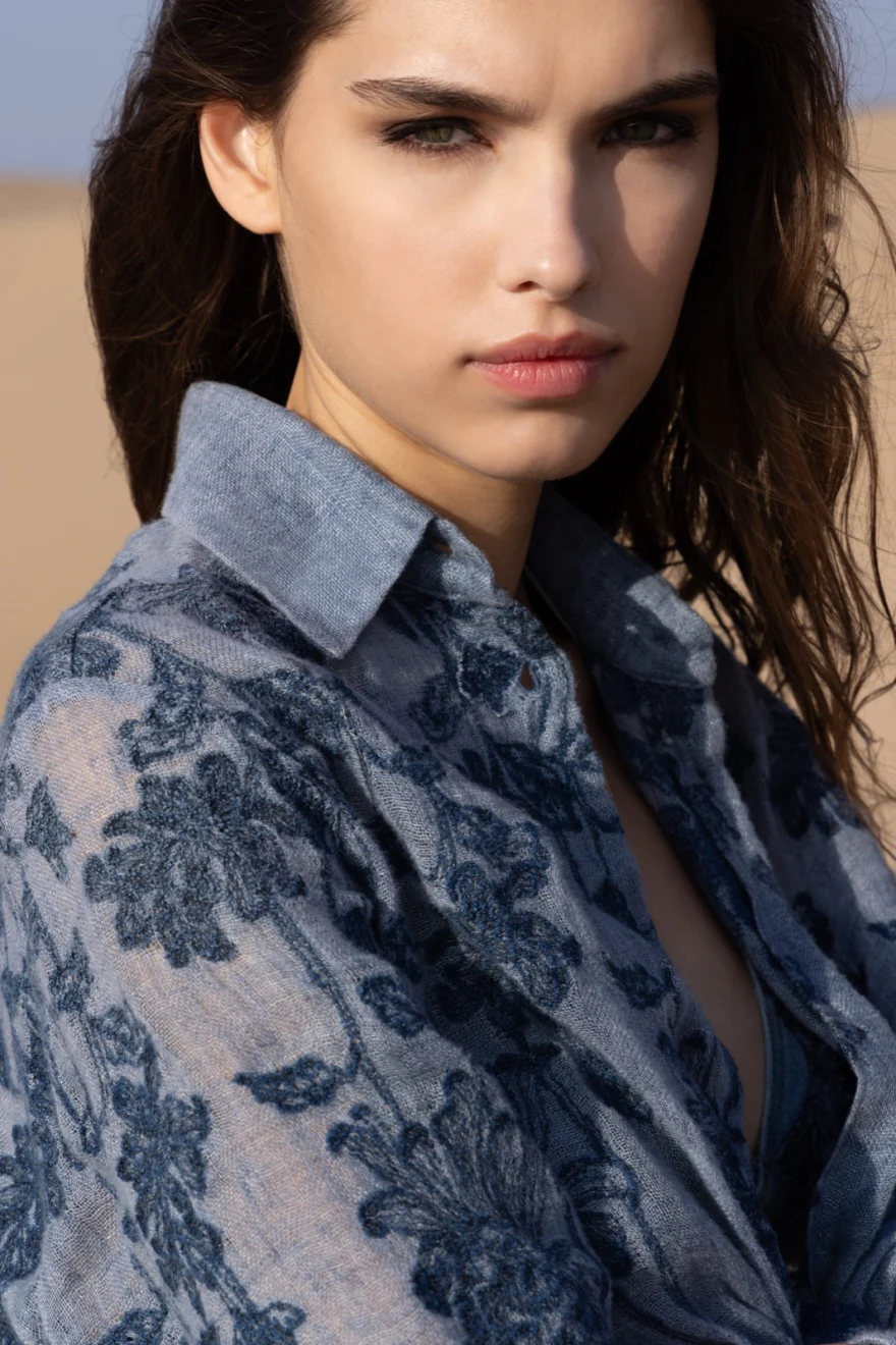 Close portrait in a blue floral embroidered denim shirt, Ermanno Scervino campaign photographed by Ina Cenusa