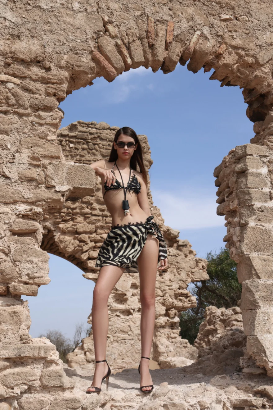 Printed swimsuit framed by a stone arch open to the sky, Ermanno Scervino campaign photographed by Ina Cenusa