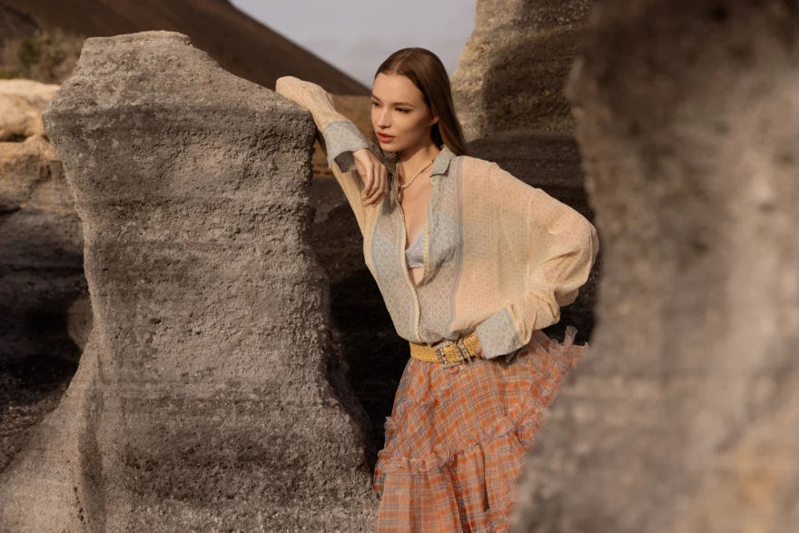 Model walking across an orange volcanic dune, Ermanno Scervino campaign photographed by Ina Cenusa