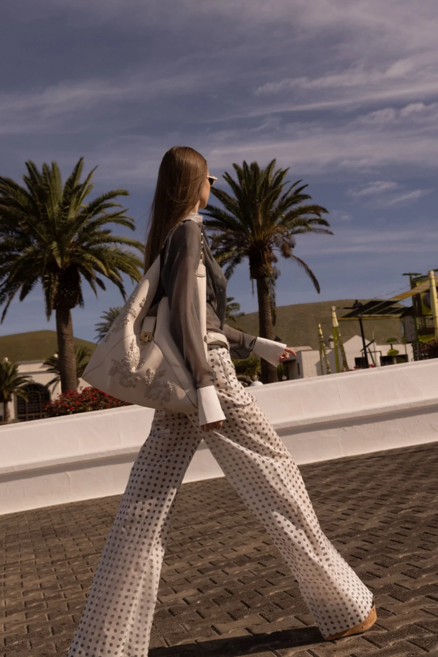 Model in a pastel look against a white wall, Ermanno Scervino campaign photographed by Ina Cenusa