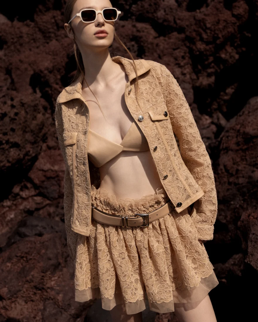 Model in a white look walking the pale dunes, Ermanno Scervino campaign photographed by Ina Cenusa