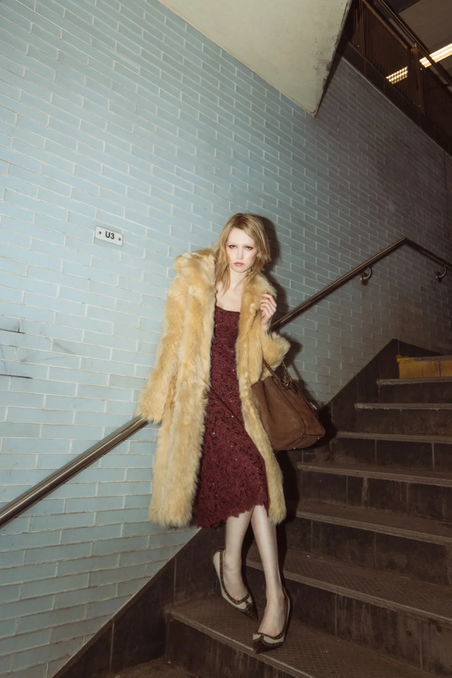Model in burgundy walking the tiled platform, Ermanno Scervino campaign photographed by Ina Cenusa