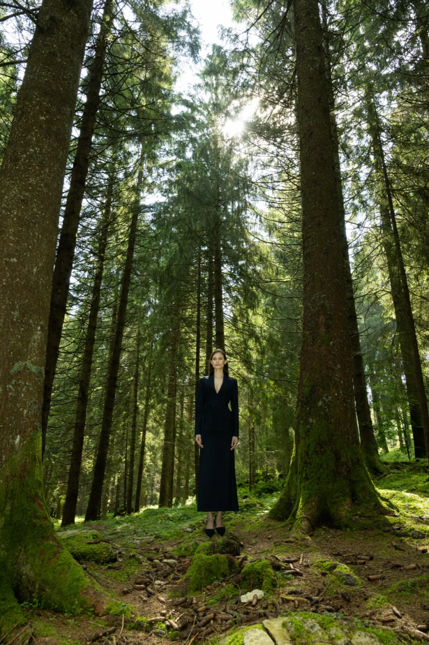 Lone figure in a dark look among tall forest trees, personal project photographed by Ina Cenusa