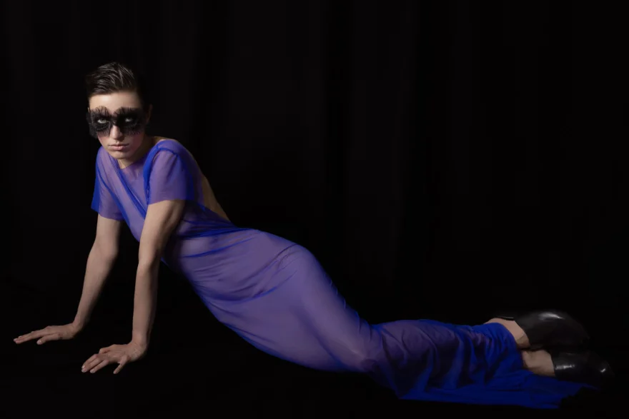 Model reclining in a blue look against black, closing image, SHOT Magazine editorial photographed by Ina Cenusa