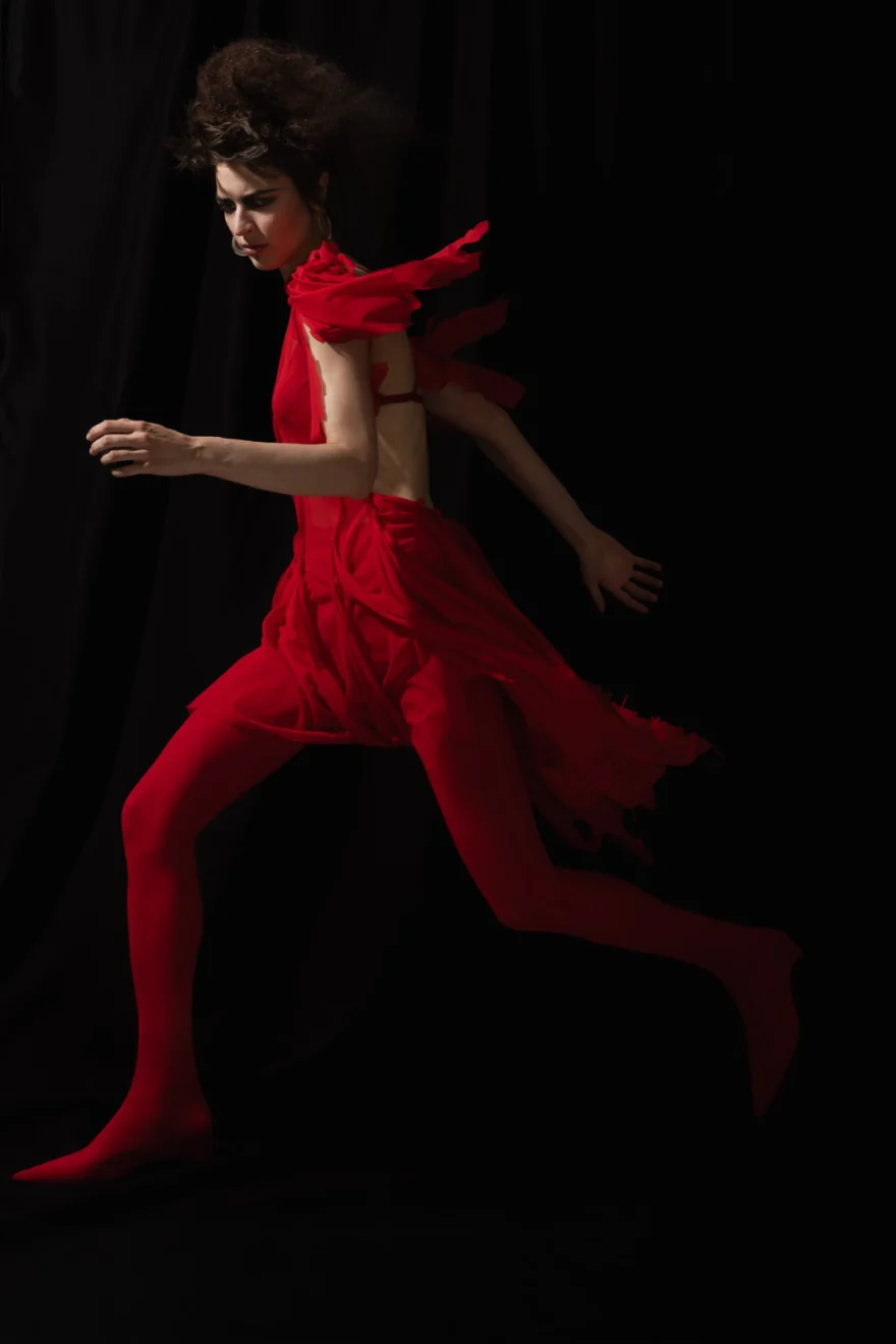 Red dress swept into movement against black, SHOT Magazine editorial photographed by Ina Cenusa