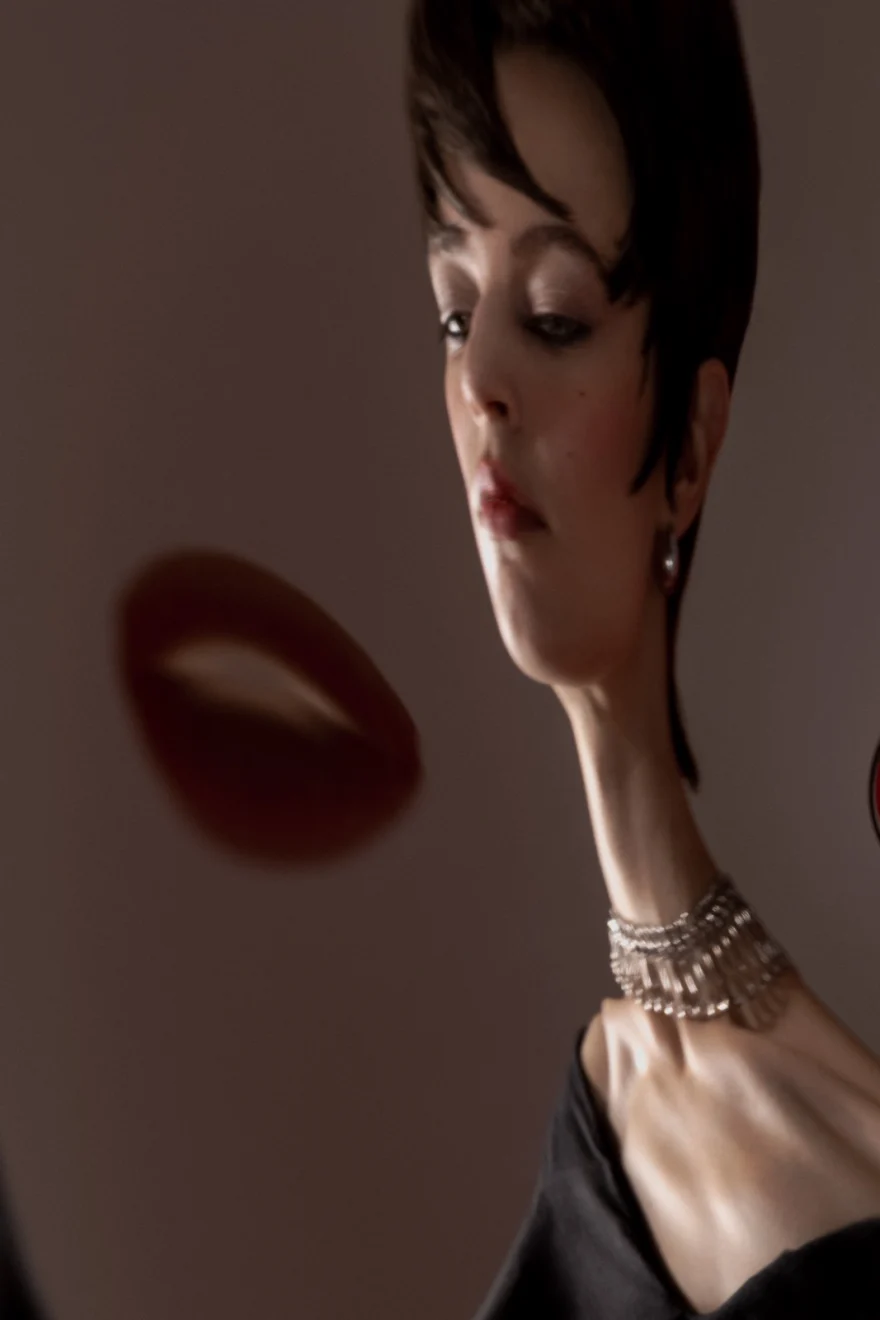 Portrait with red form in the foreground and gold jewellery, SHOT Magazine editorial photographed by Ina Cenusa