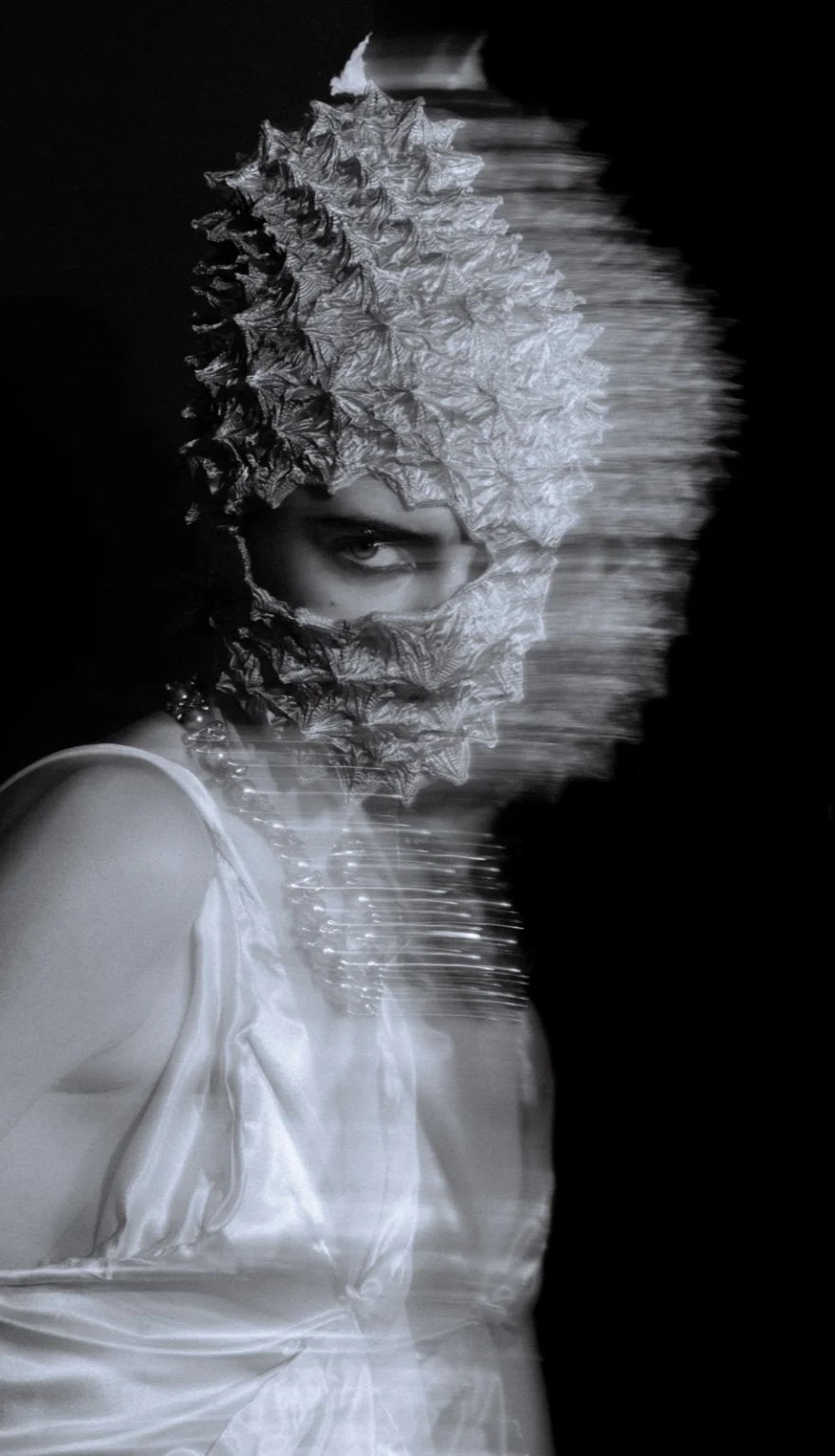 White pleated look and sculptural headpiece caught in motion, SHOT Magazine editorial photographed by Ina Cenusa