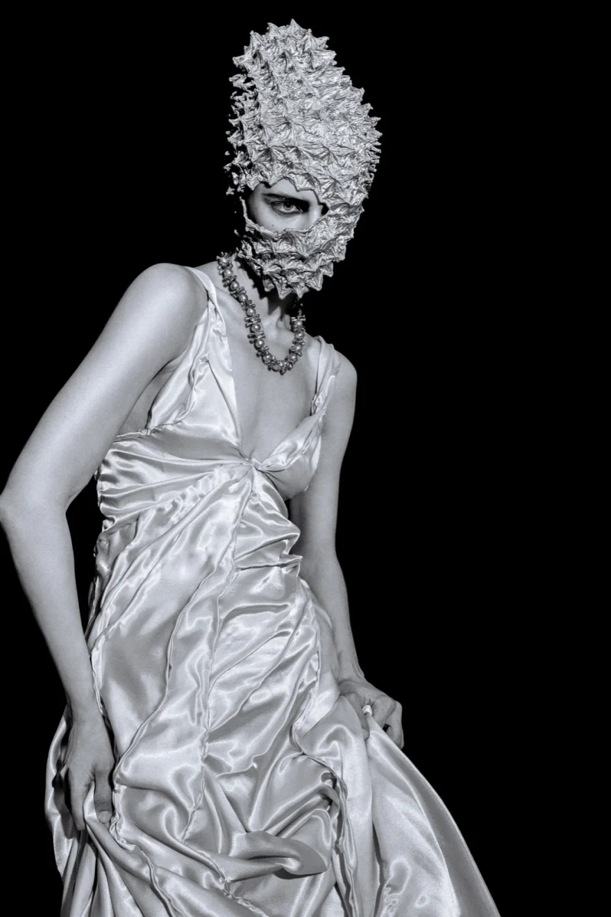 Model in a white sculpted gown with a textured headpiece against black, SHOT Magazine editorial photographed by Ina Cenusa