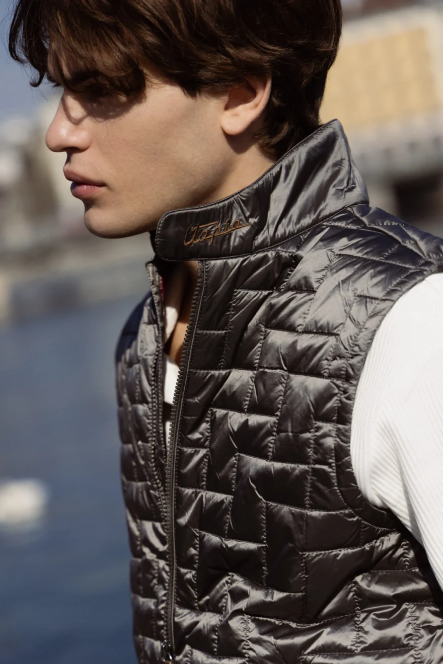 Profile portrait of a model in a quilted gilet by the water, Pagani campaign in Geneva photographed by Ina Cenusa